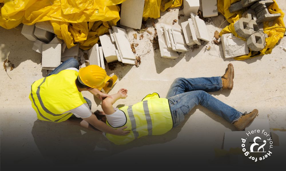 Injured construction being helped by a co-worker