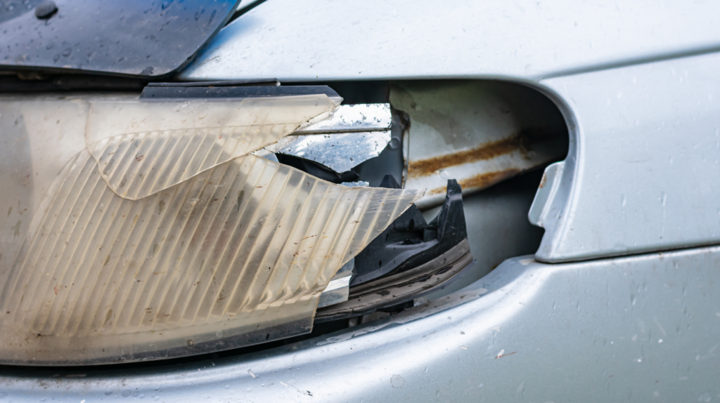 A minor car accident showing the left headlights broken