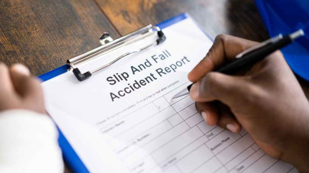 A man filling a slip and fall accident report form