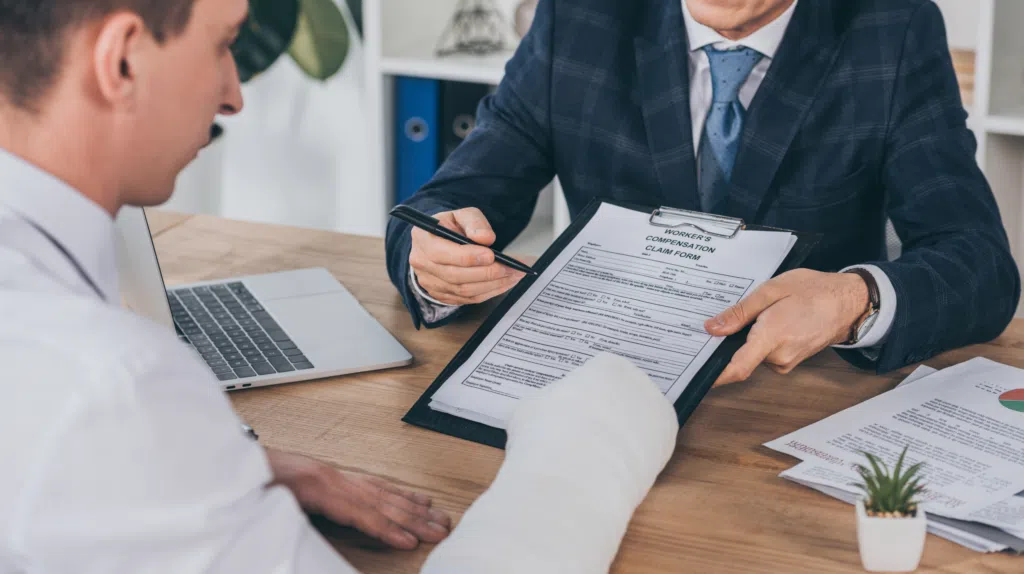 An injured worker talking to a lawyer about workers compensation