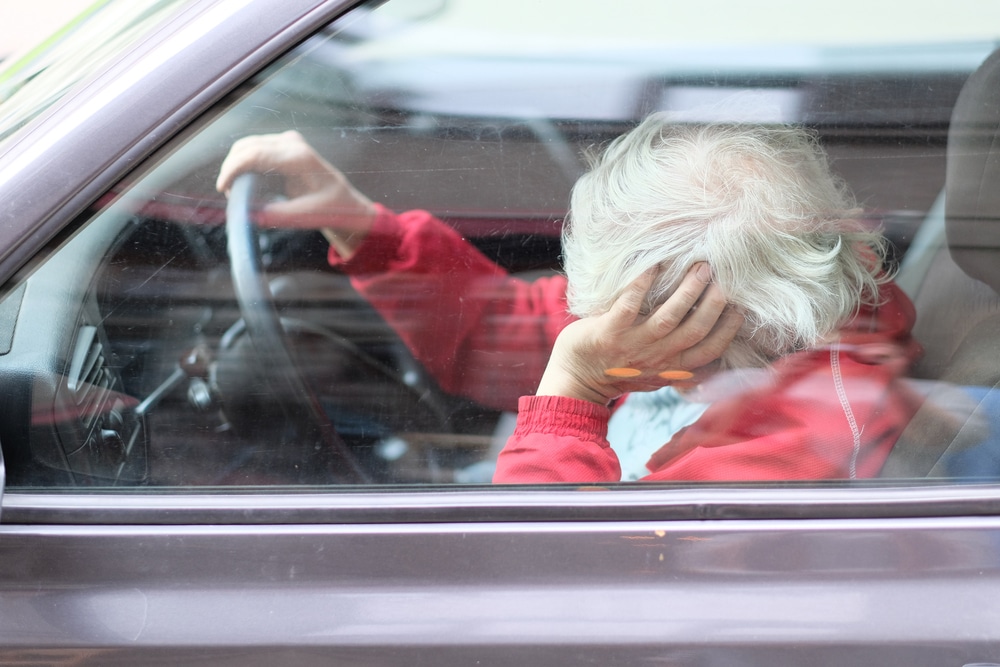 old woman sleeping in driver's seat