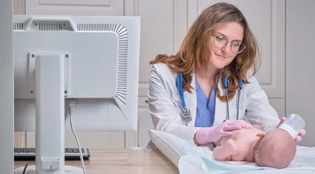a doctor feeding a baby