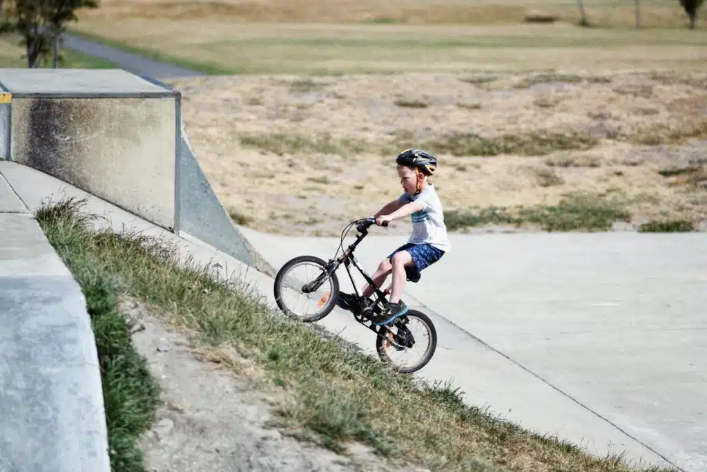 A boy driving a bicycle on a sloppy way