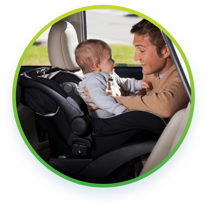 a man holding a baby at the back seat of a car