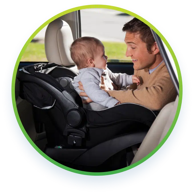 a man holding a baby at the back seat of a car