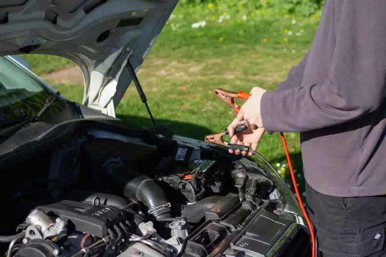 a man doing battery jump start