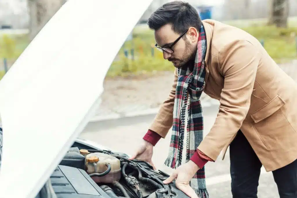 a man looking for faults in his break down vehicle