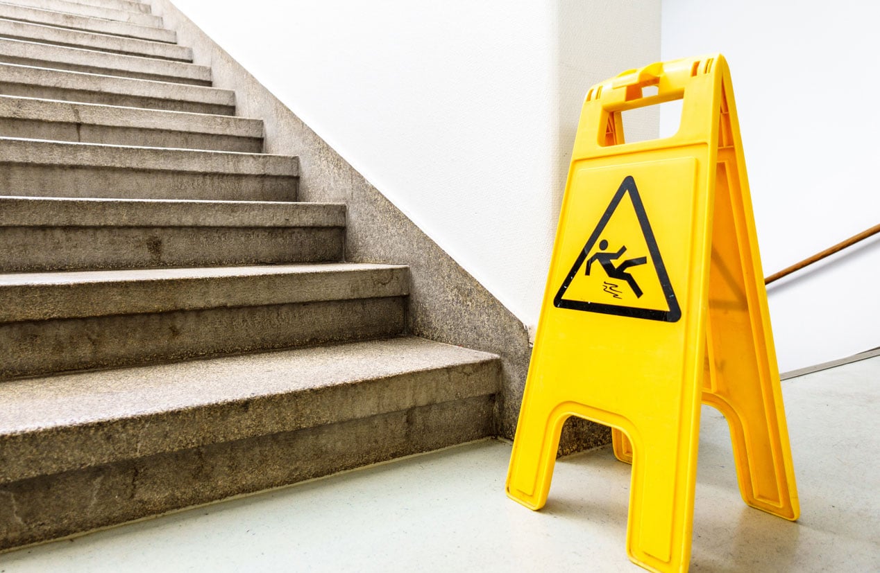 A slip and fall signal in front of a staircase