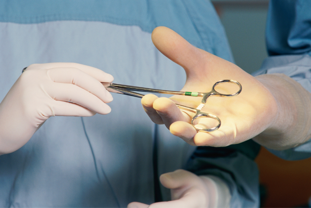 Doctor handing over medical tool during surgery