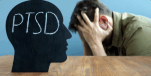 A man with mental health issues holding his head