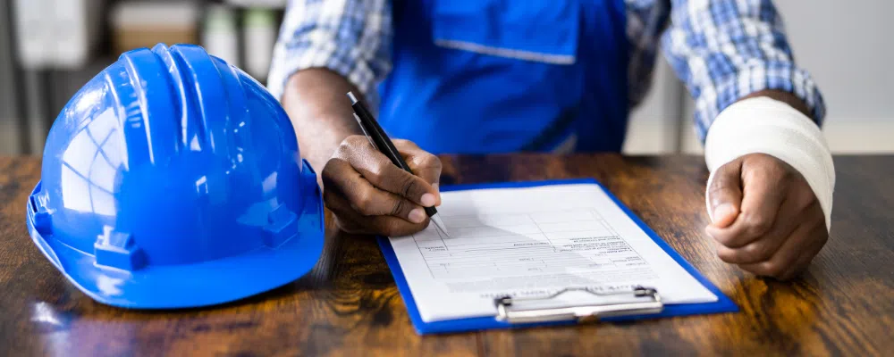 injured construction worker filling out paper work