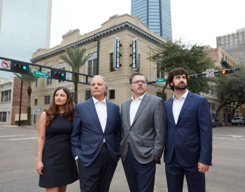 The Farah team group photo outside the firm's office building - personal injury attorneys serving Jacksonville, FL