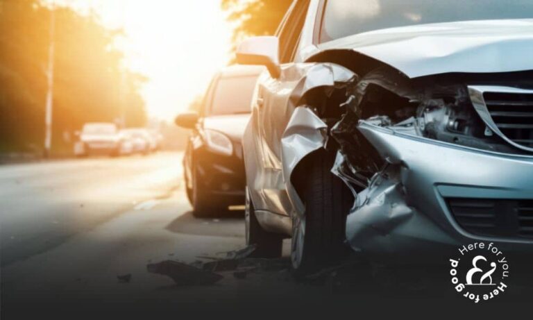 A damaged car on a road following a car accident