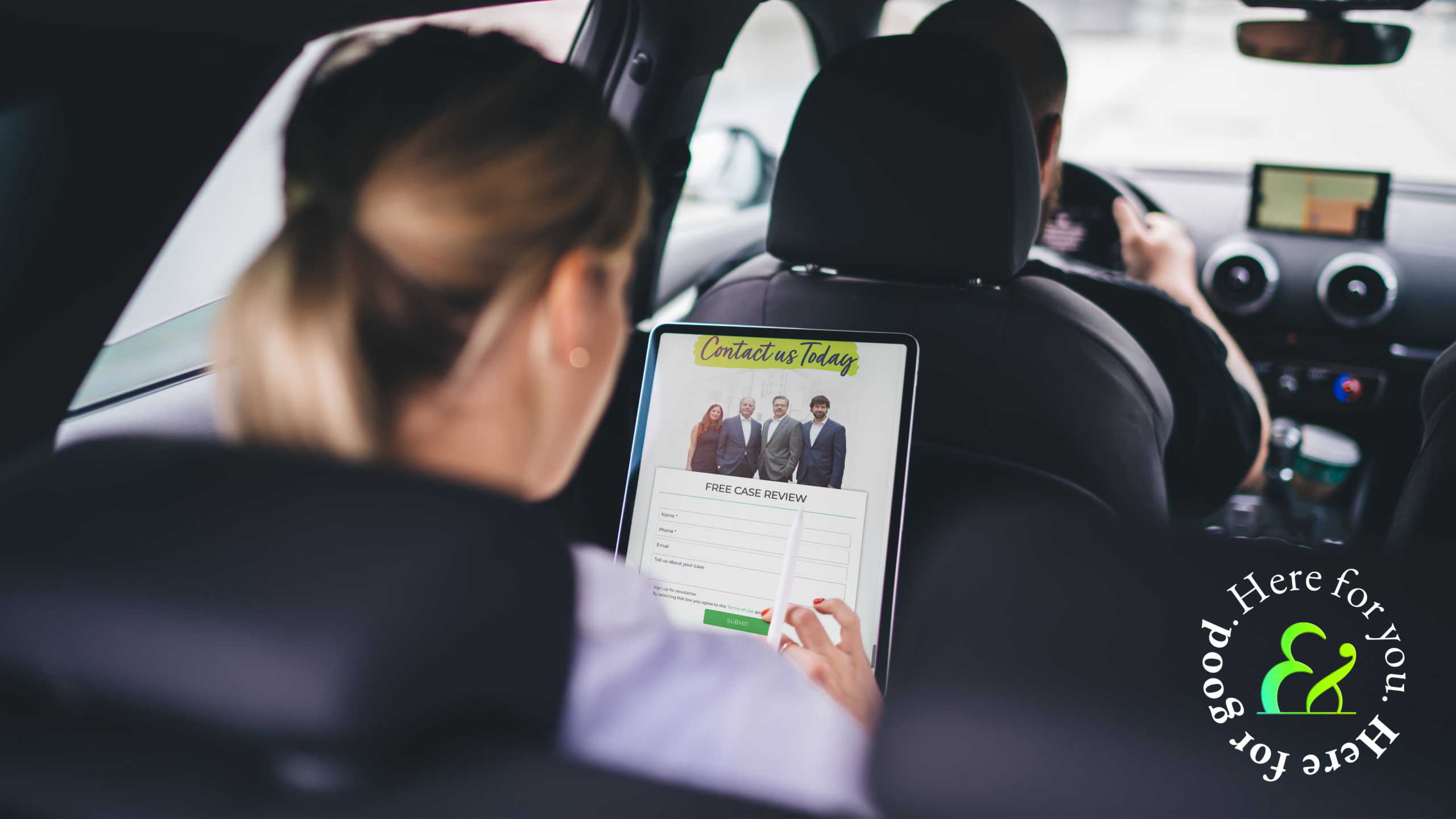 a passenger sitting in the back seat of an Uber viewing an Uber attorney website on a tablet