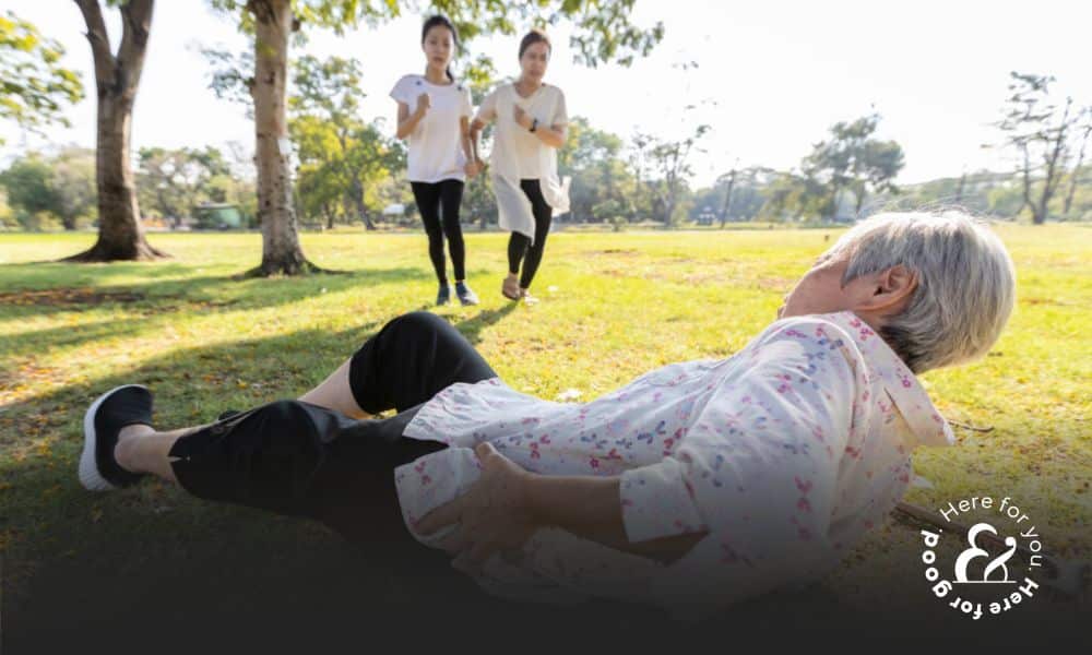 an elderly woman with a cane who has slipped and fallen on the ground while her granddaughters rush to help her