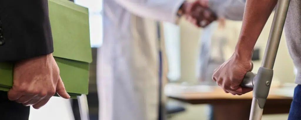 personal injury lawyer and client at doctors office