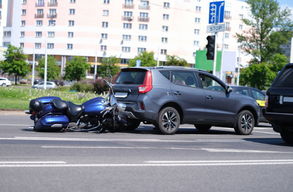 car rear ends a blue motorcycle