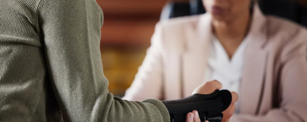 man with broken wrist talking to a personal injury lawyer