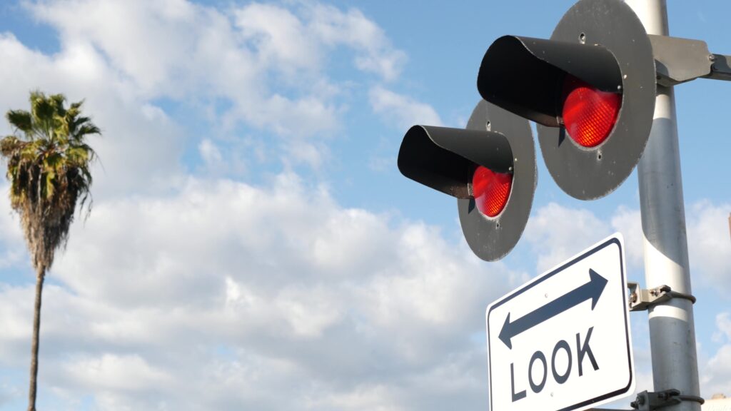 a red traffic light at a railroad crossing designed to prevent traffic accidents