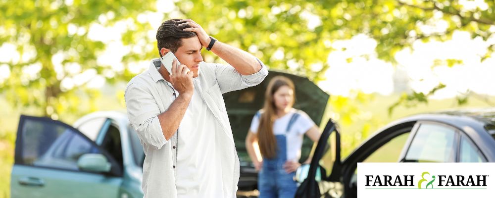 person talking on phone after car accident