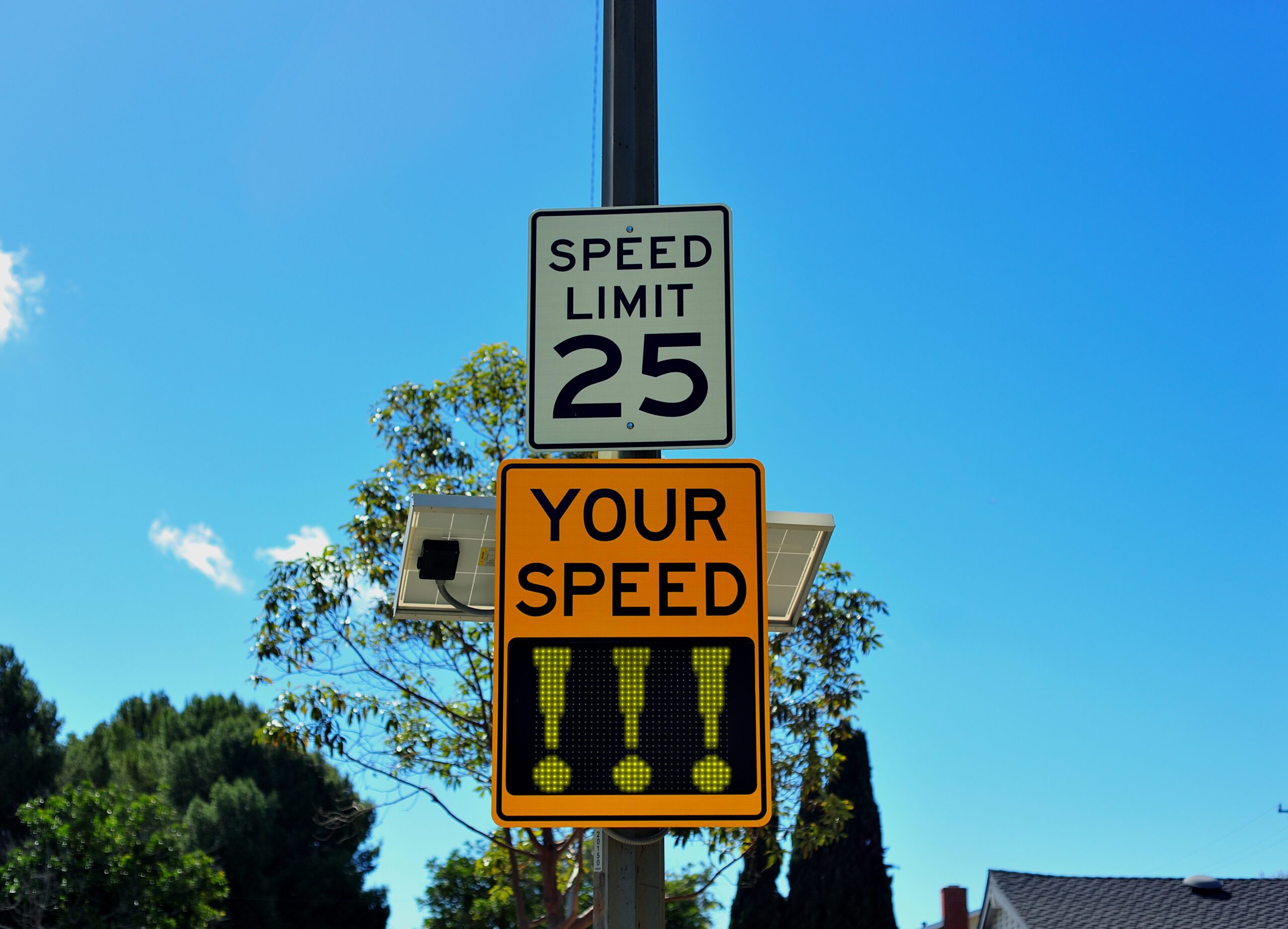 a speed limit 25 mph sign with a Your Speed digital sign showing exclamation points to demonstrate that the driver was speeding