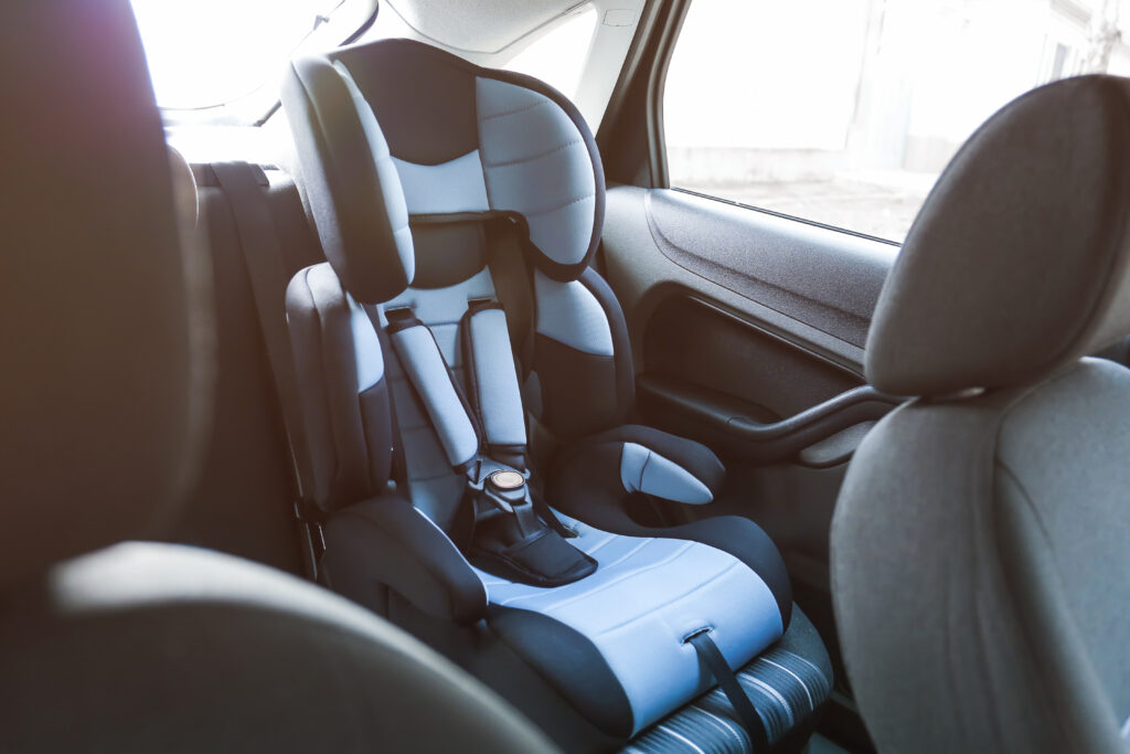 a child's car seat empty in the back seat of a car to protect against car accidents