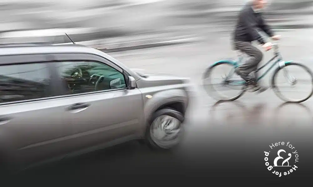 car about to hit bike and bicycle rider