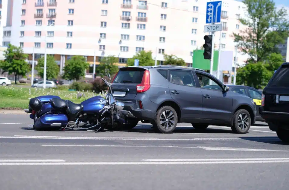 car rear ends a blue motorcycle