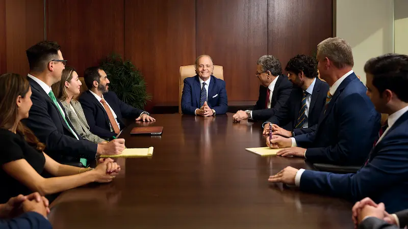 Farah and Farah personal injury lawyers sitting at conference table