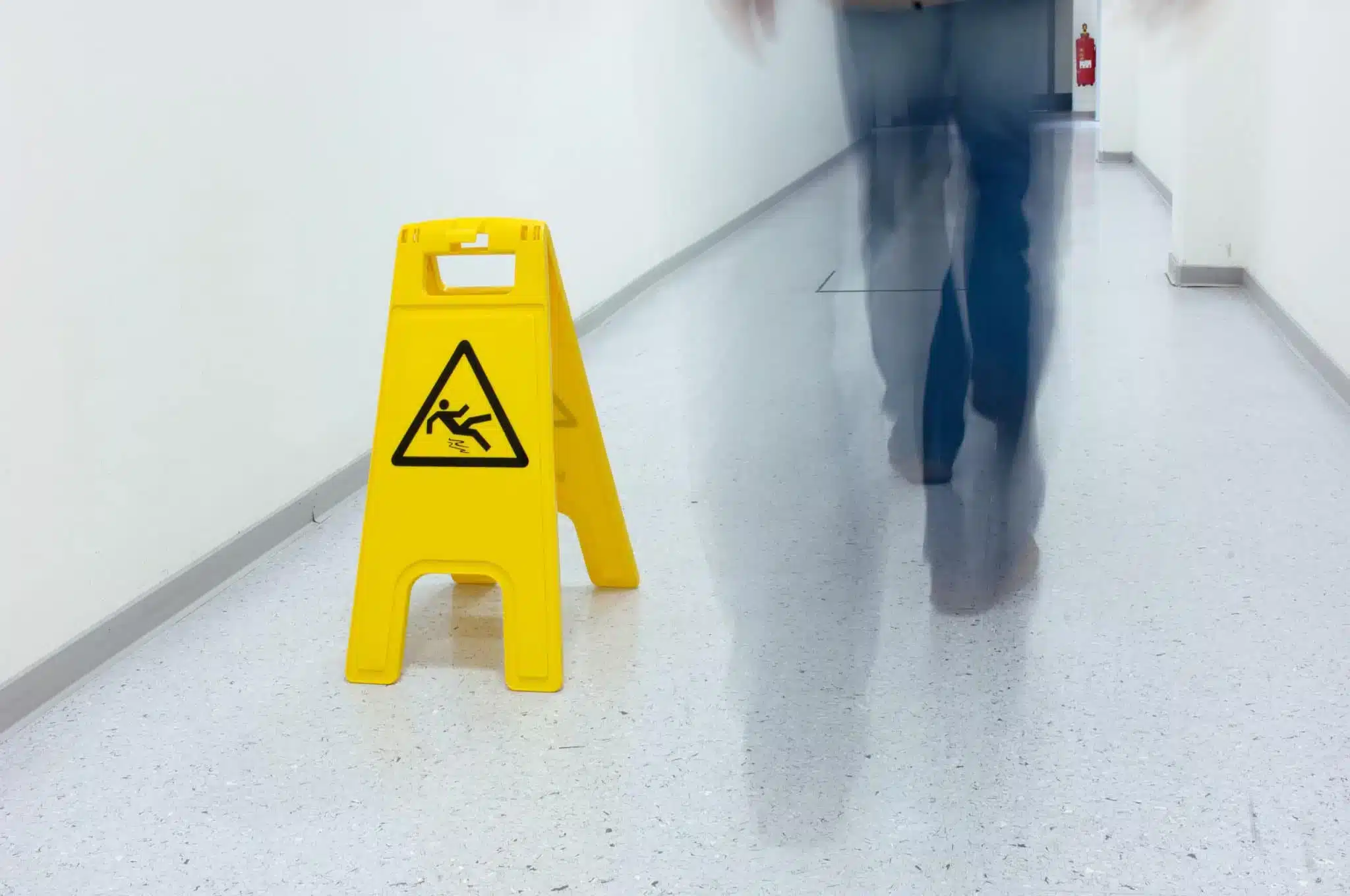 A wet floor sign in a hallway