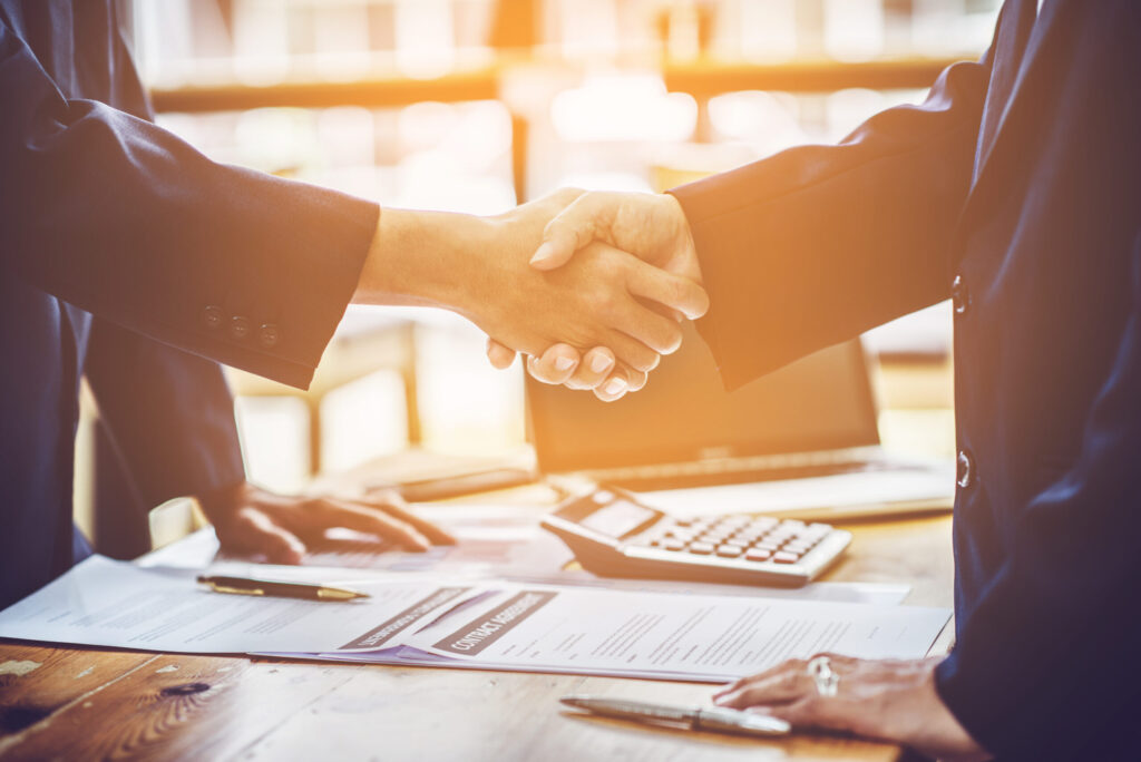 attorney and client shaking hands after settlement and attorneys fees