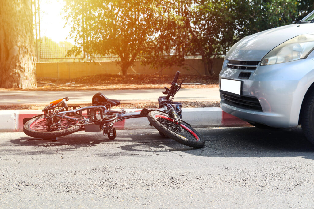 an electric bike knocked over by a car accident