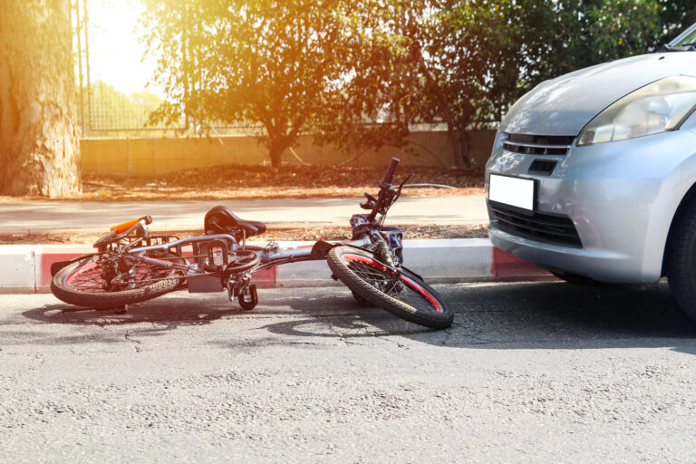 an electric bike knocked over by a car accident