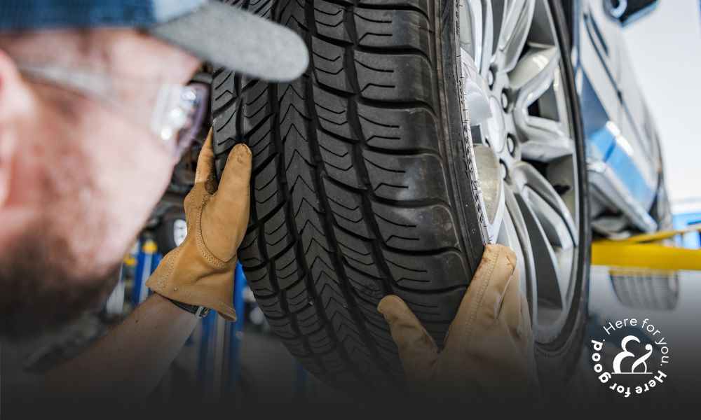 Mechanic looking at a car tire that requires maintenance