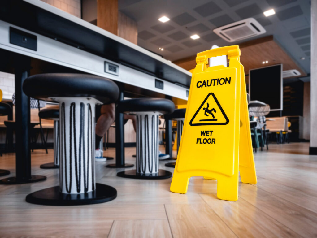 a caution wet floor sign in a casual restaurant out to prevent slip and fall accidents