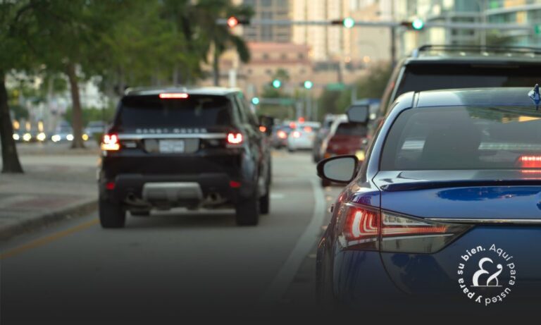 Cars in traffic driving on street with traffic lights in Florida